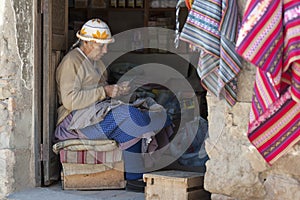 Unidentified indigenous native Quechua woman with traditional tribal clothing and hat, at the Tarabuco Sunday Market, Bolivia
